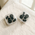 Two clear cases of earplugs and ear tips side by side on a white bed
